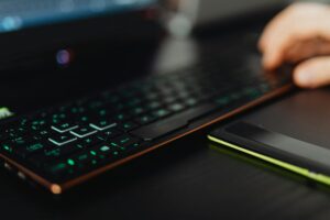 Modern gaming laptop displaying colorful game interface on screen