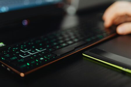 Modern gaming laptop displaying colorful game interface on screen