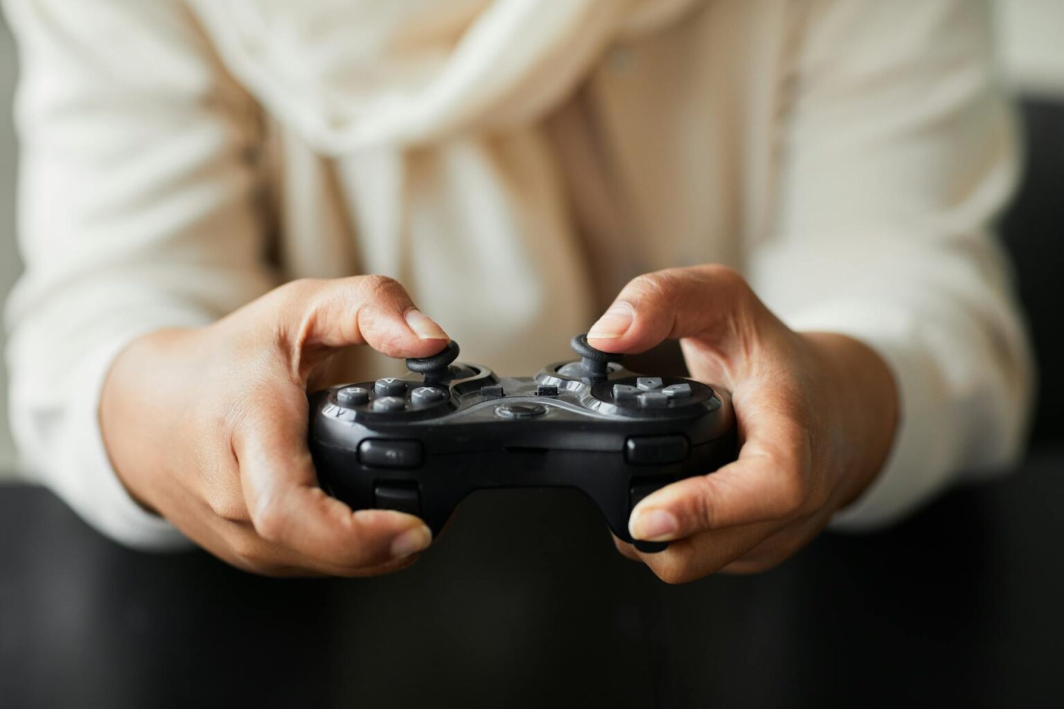 Why Sony’s Mobile Gaming Controller Is Outperforming Backbone’s Design Hands holding a modern gaming controller for mobile gaming