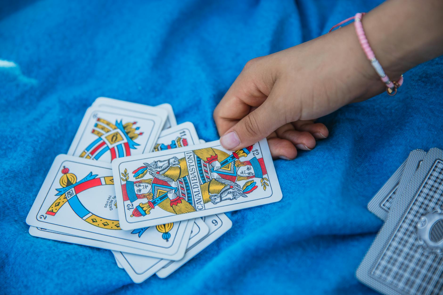 Colorful trading cards spread across a table showing the collectible card game experience