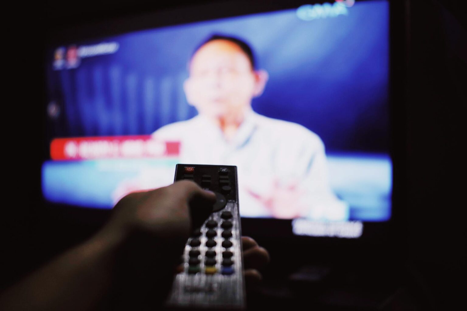 Modern smart TV remote control on coffee table showing streaming interface options