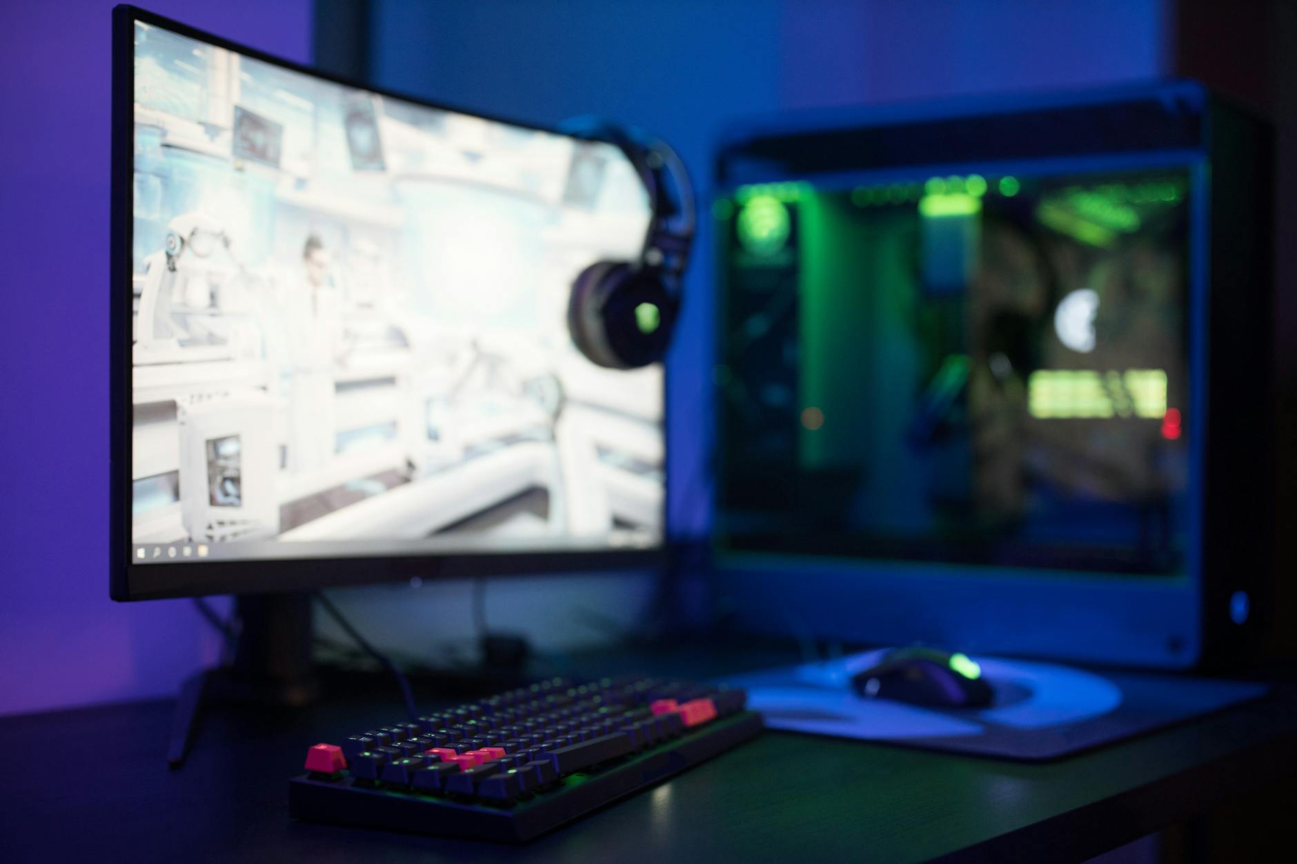 Modern PC gaming setup with keyboard, mouse and monitor displaying game interface