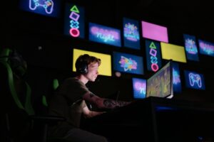 A digital presentation screen showing gaming content in a modern setup