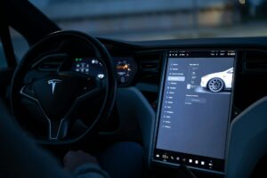 Modern electric vehicle interior showing large touchscreen display and dashboard controls