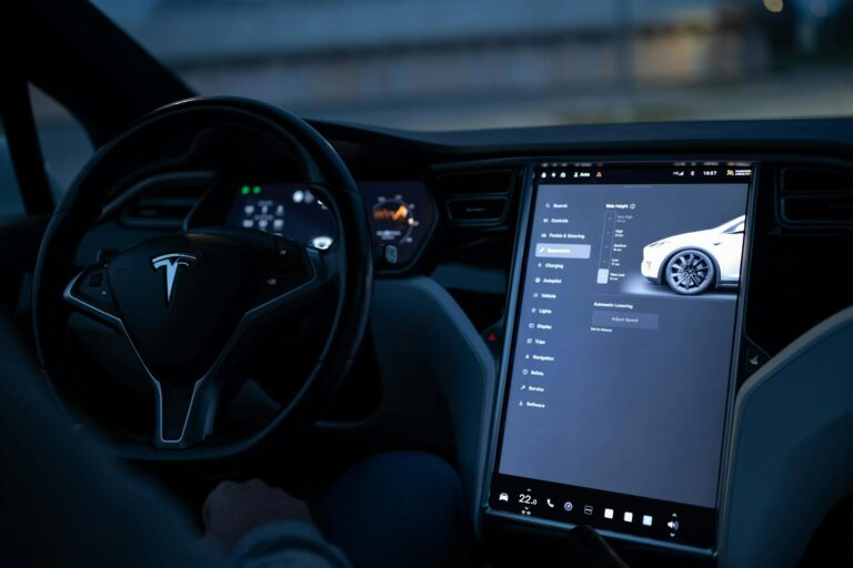 Modern electric vehicle interior showing large touchscreen display and dashboard controls