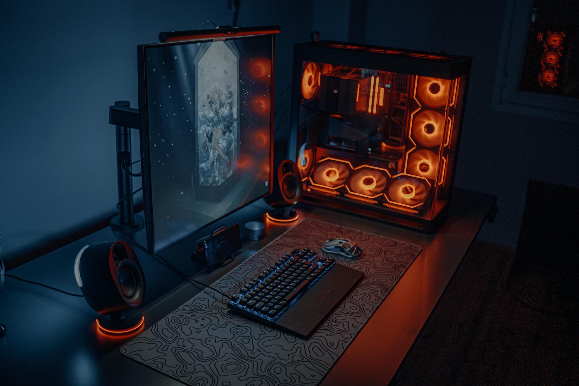 Gaming computer setup with multiple monitors displaying game development interface