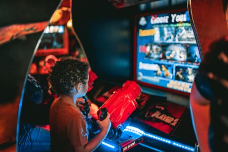 How Retro Gaming Cafes Are Becoming Social Hubs in Major Cities Vintage arcade game cabinets lined up in a retro gaming cafe with colorful screens and classic joystick controls
