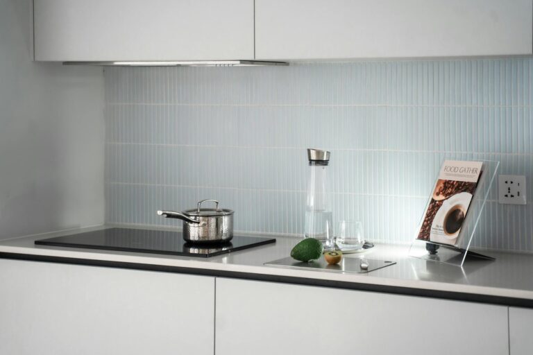 Open cookbook on kitchen counter with cooking ingredients and utensils around it