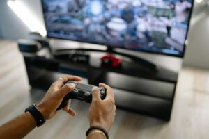 Gaming console and controller on wooden surface representing retro gaming collection