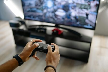 Gaming console and controller on wooden surface representing retro gaming collection