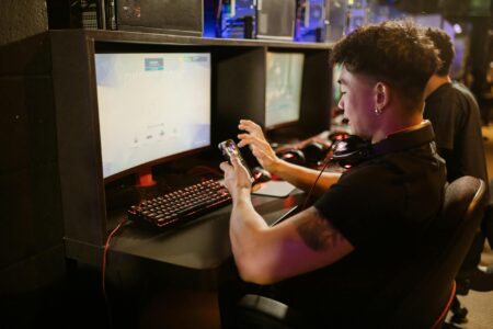 Mobile phone displaying gaming content on screen with colorful interface