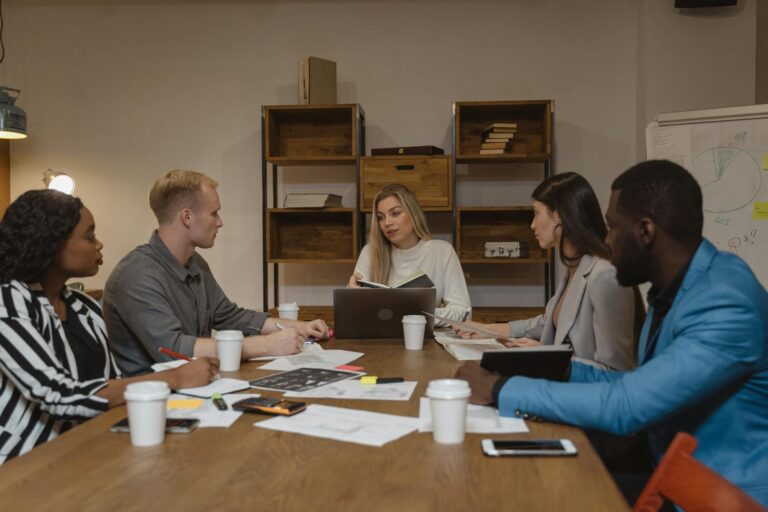 Business professionals discussing strategy in modern office meeting room