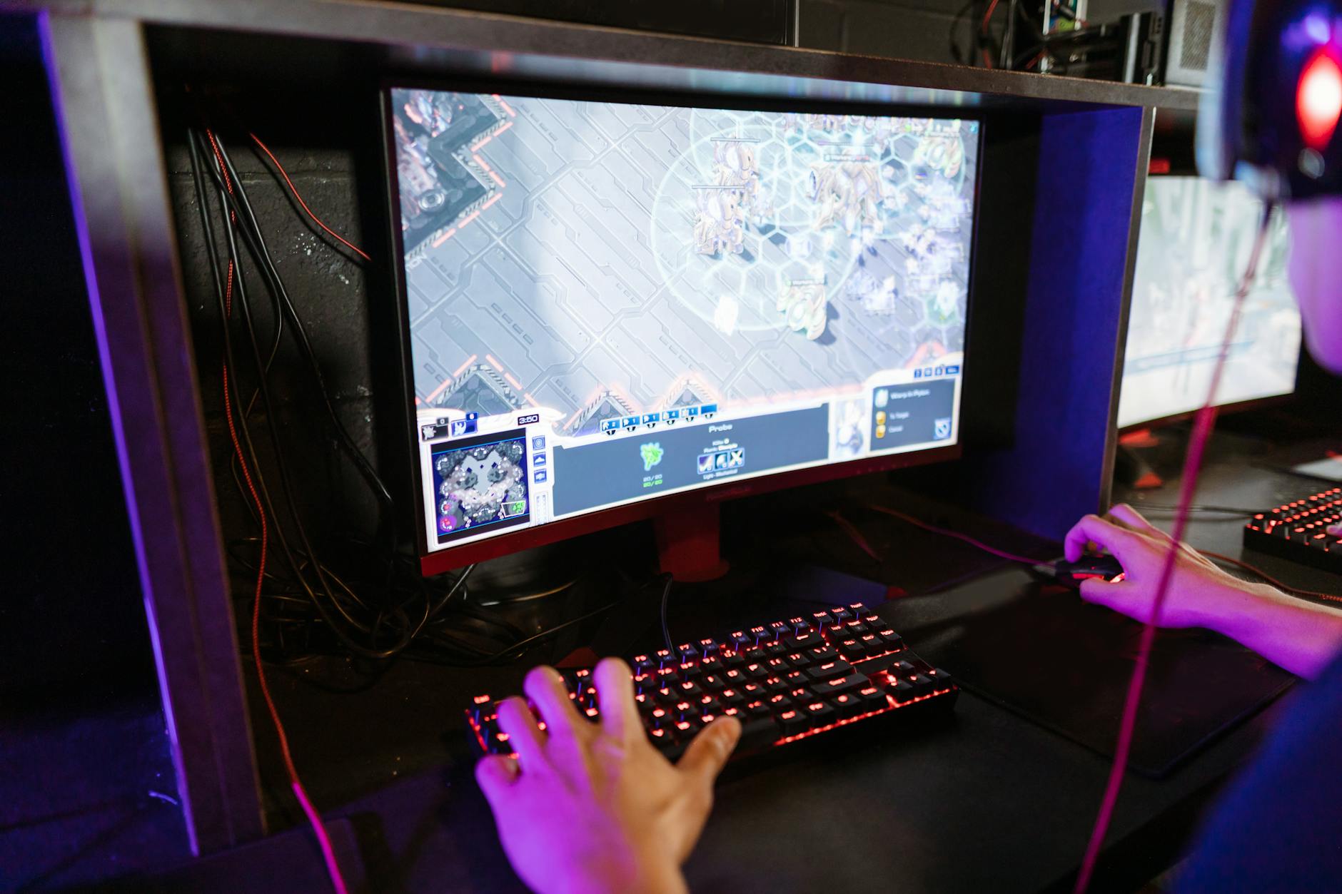 Gaming setup with computer screen displaying Steam interface and game library