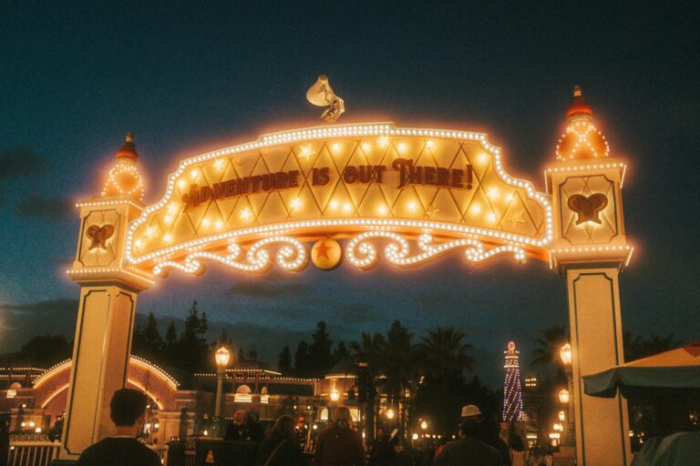 Colorful theme park entrance with decorative archway and landscaped gardens