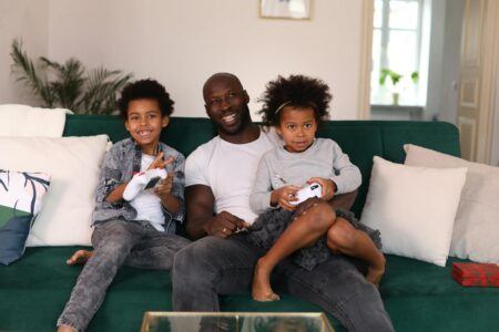 How Game Pass Family Sharing Is Finally Competing with Netflix Subscriptions Family members playing video games together in living room setting