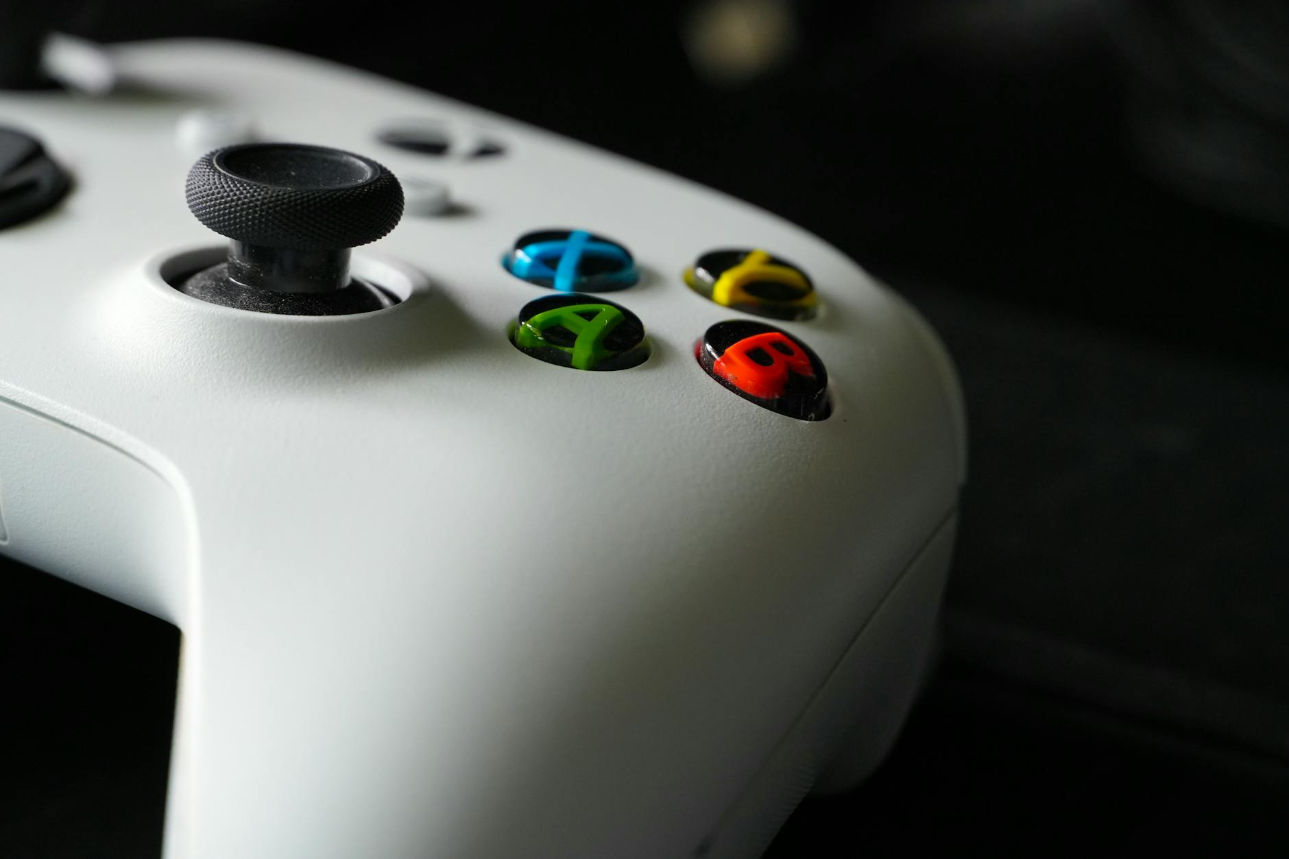 Wireless gaming controller positioned in front of large screen display