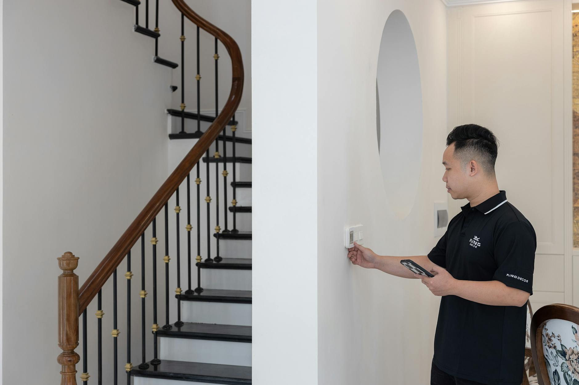 Hand holding smartphone controlling smart home devices with icons floating above