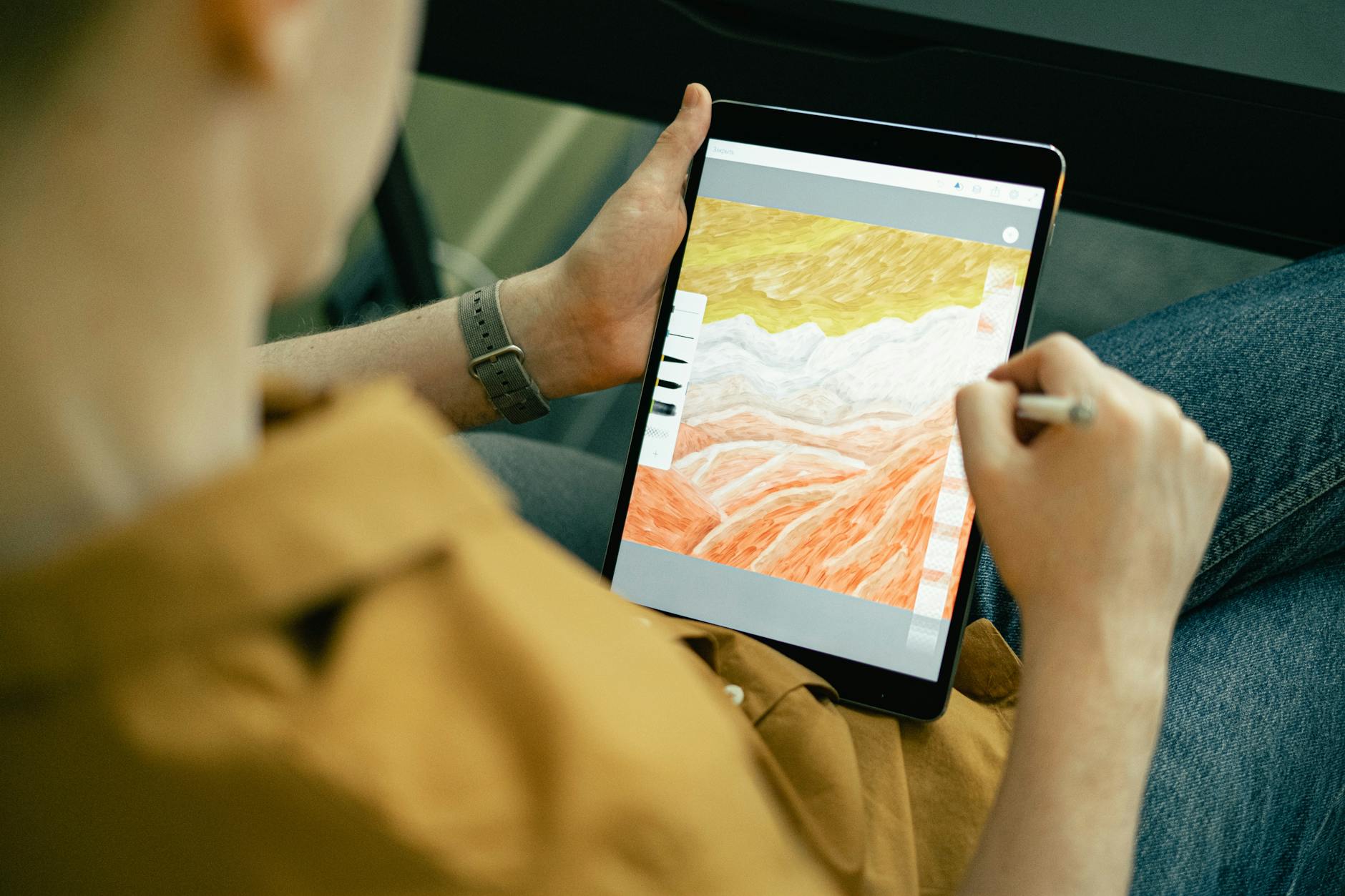 Digital artist working on 3D modeling software creating game assets on computer screen