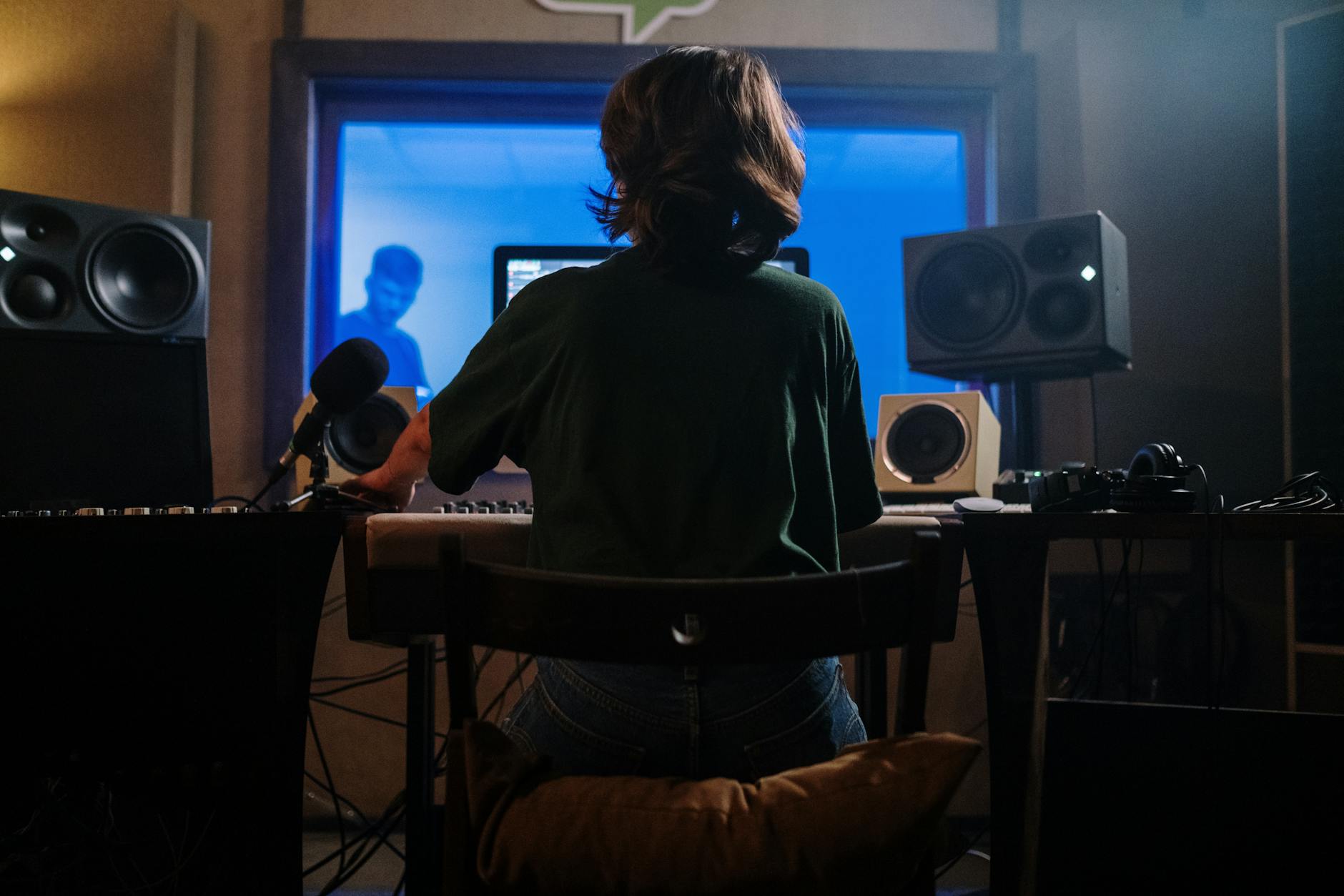 Professional music recording studio with mixing board, monitors, and acoustic panels