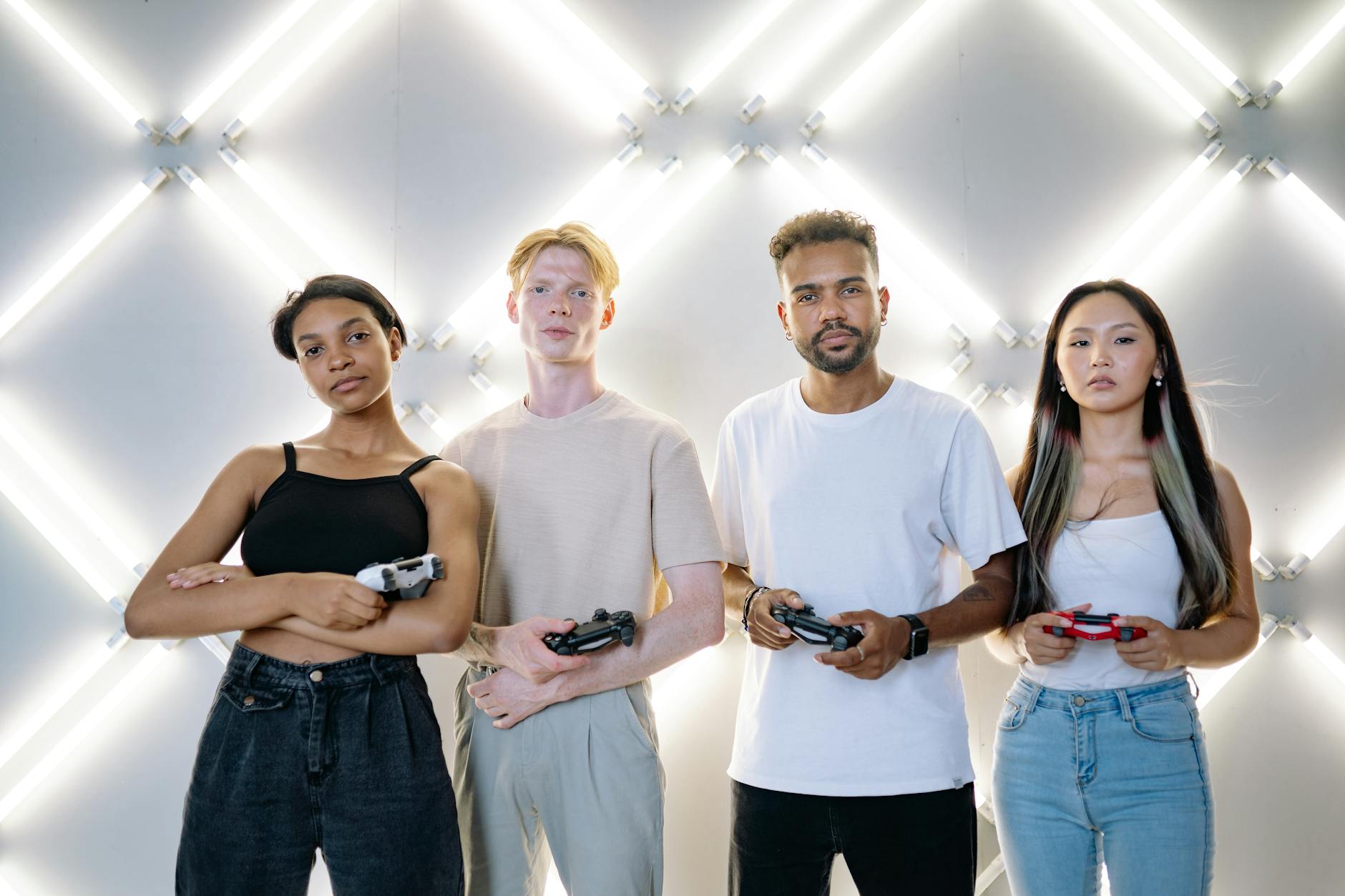 Group of diverse young adults playing video games together in a modern gaming cafe environment