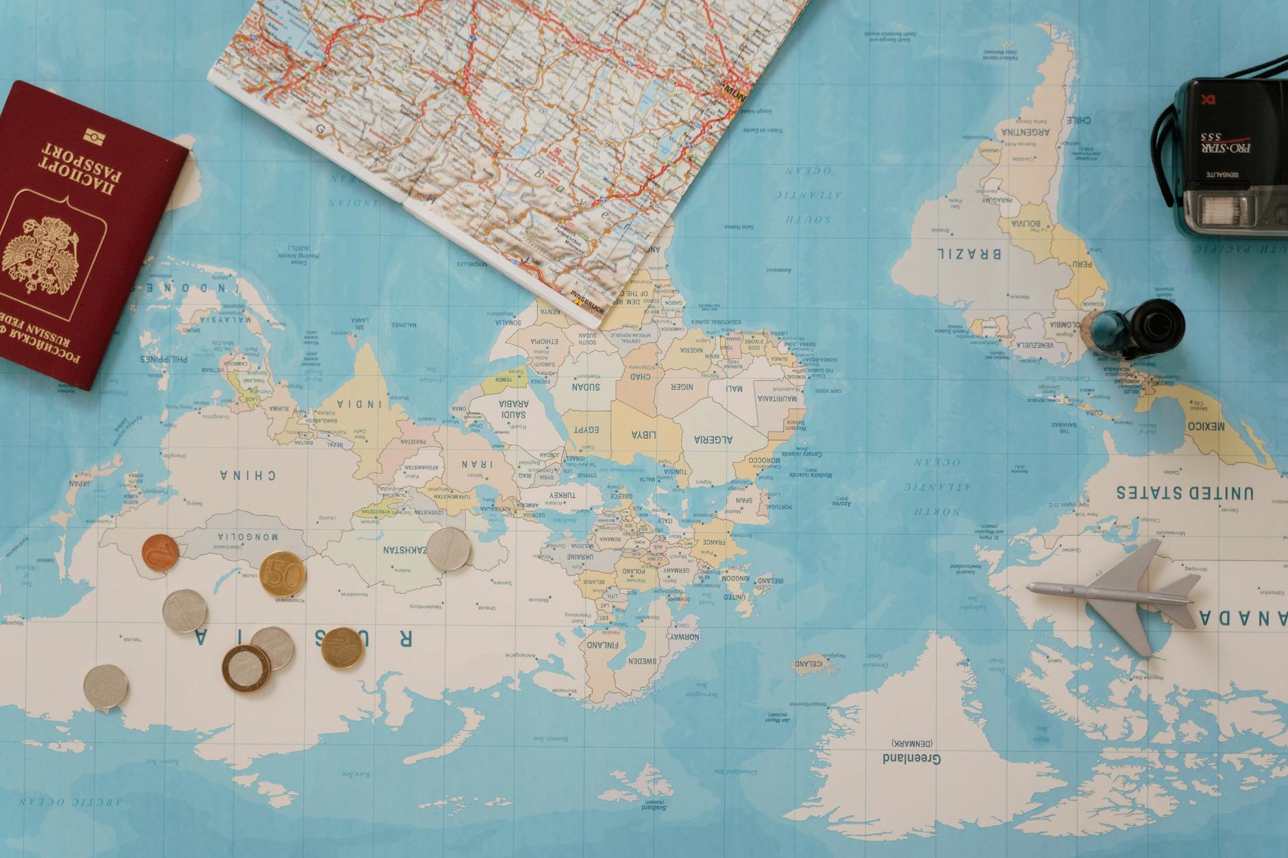 World map with various international currency symbols representing global pricing strategies