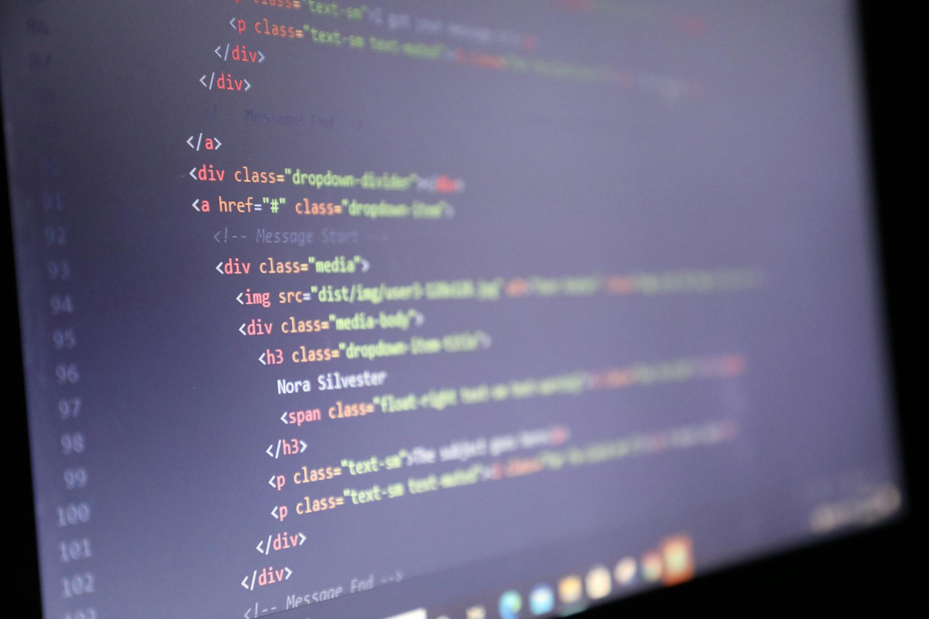 Software developer working on code at computer workstation