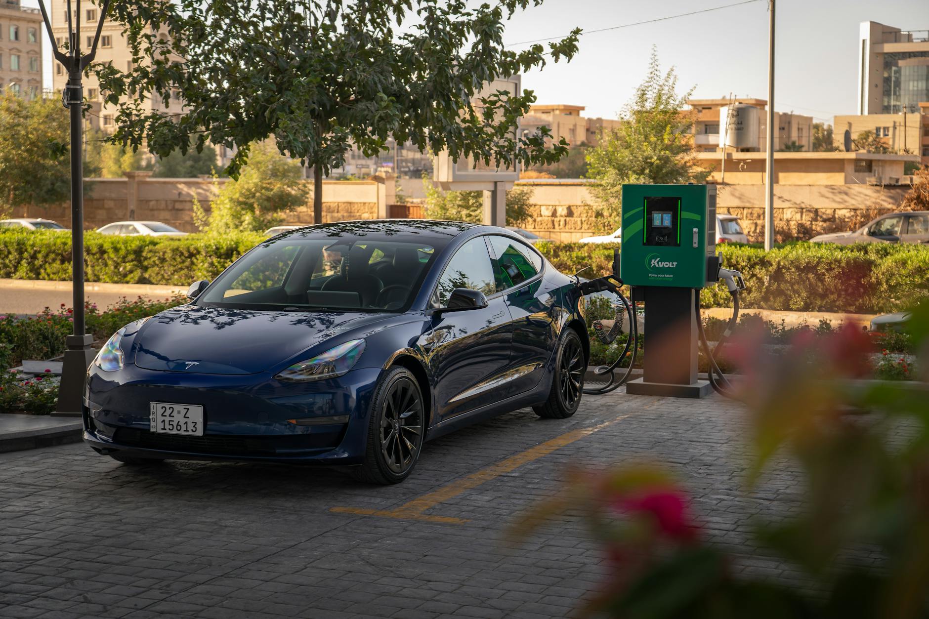 Electric vehicle charging station illuminated at night with multiple charging ports