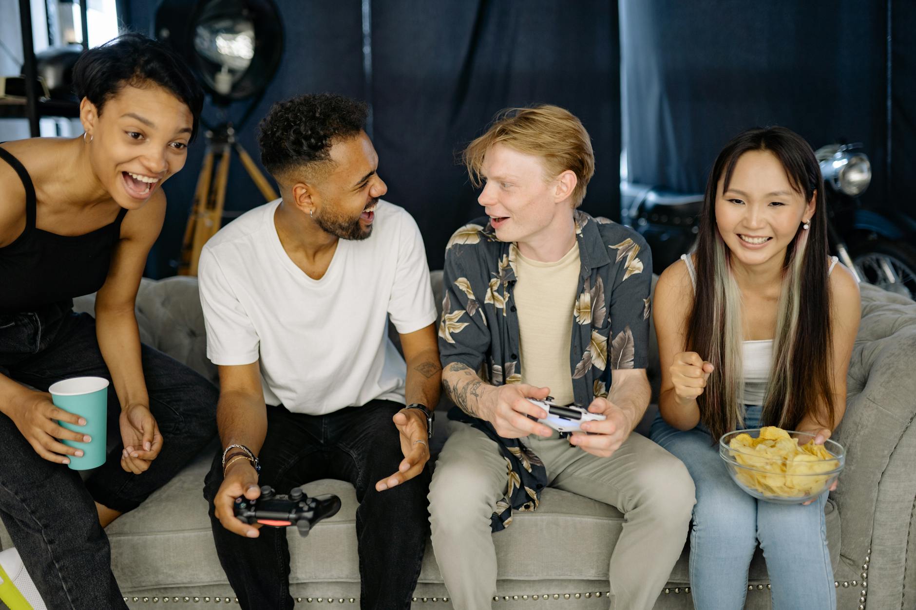 Group of friends playing video games together on computers in a modern gaming environment