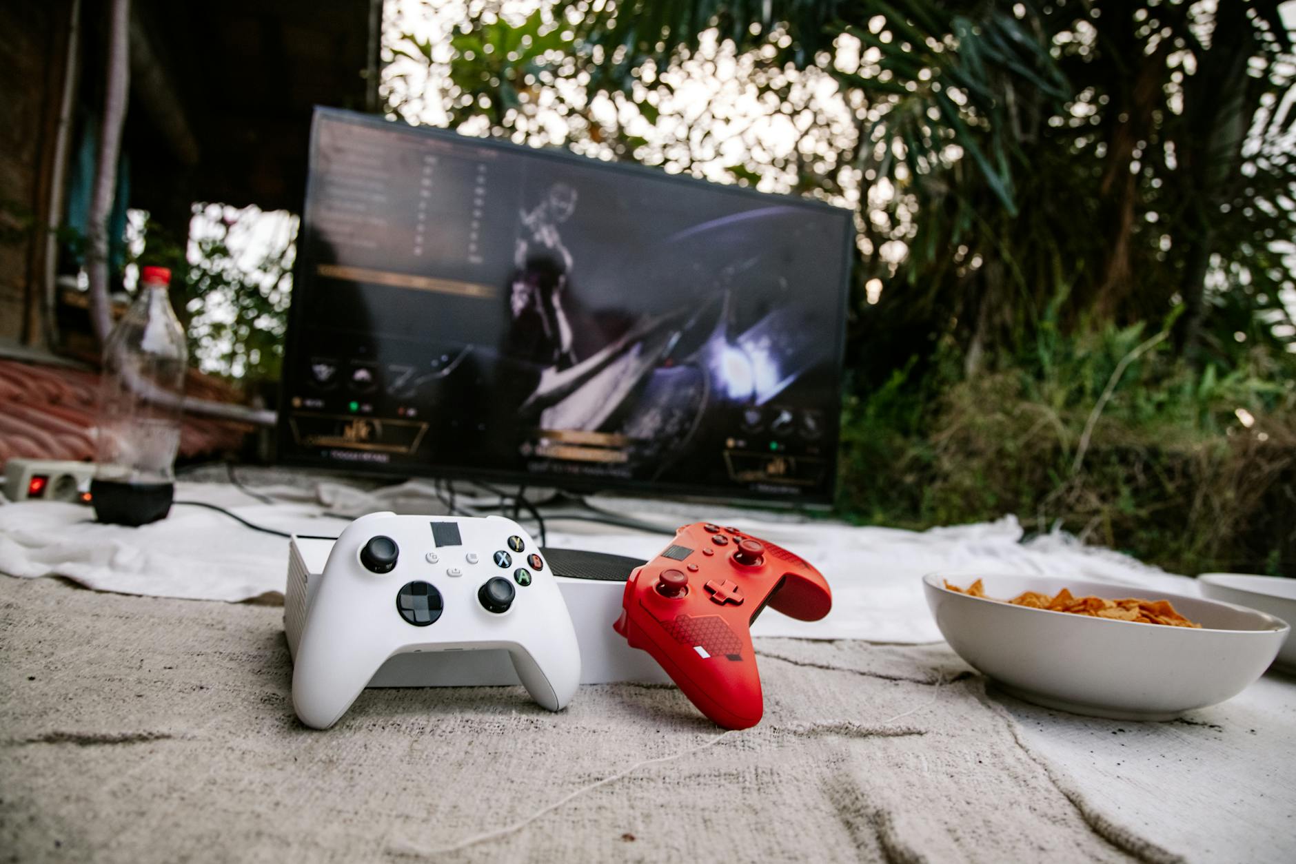 Xbox gaming console setup with controller and monitor displaying game content