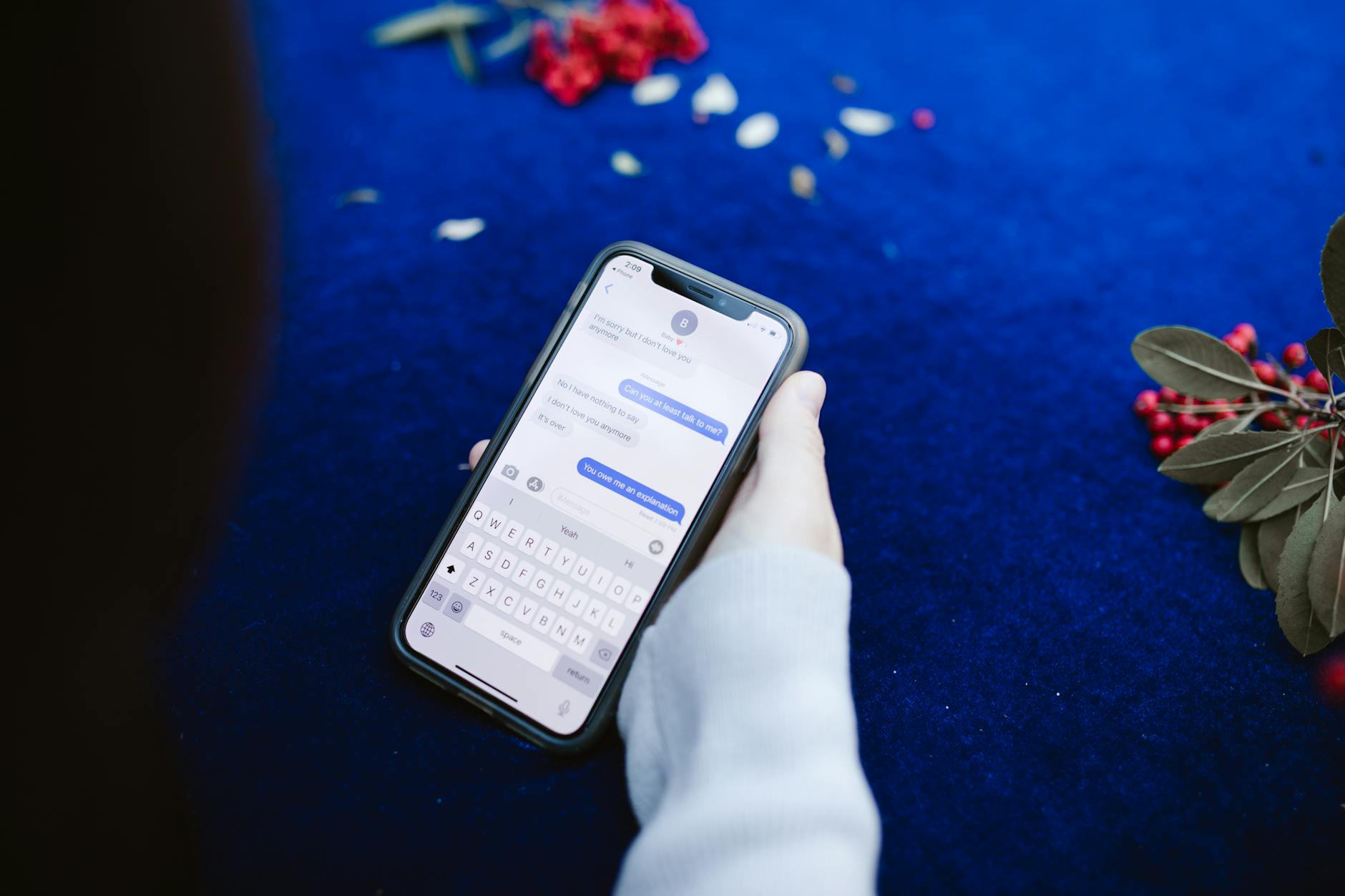 Person using mobile phone to participate in chat application interface