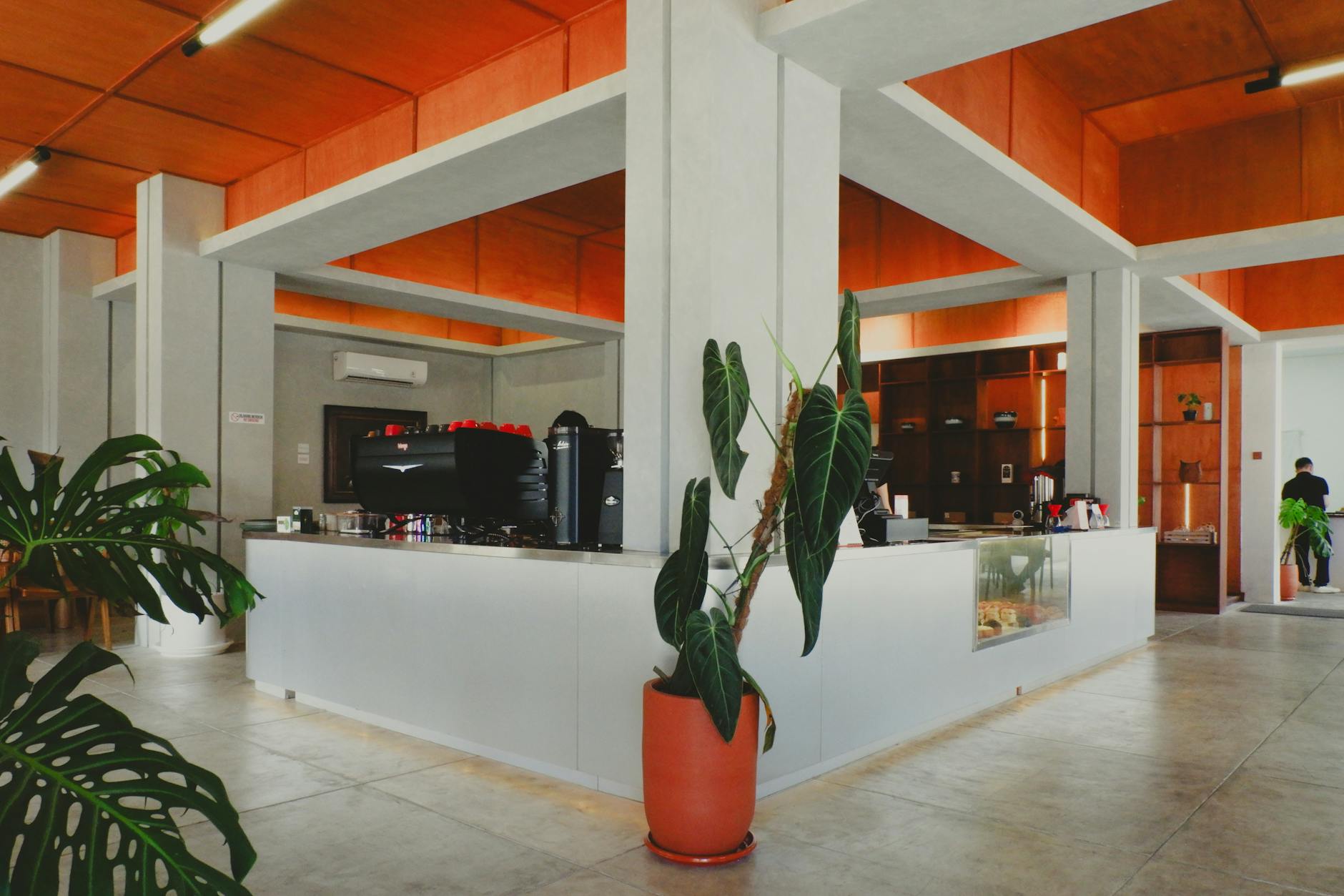 Interior view of a modern cafe space with seating areas and entertainment equipment