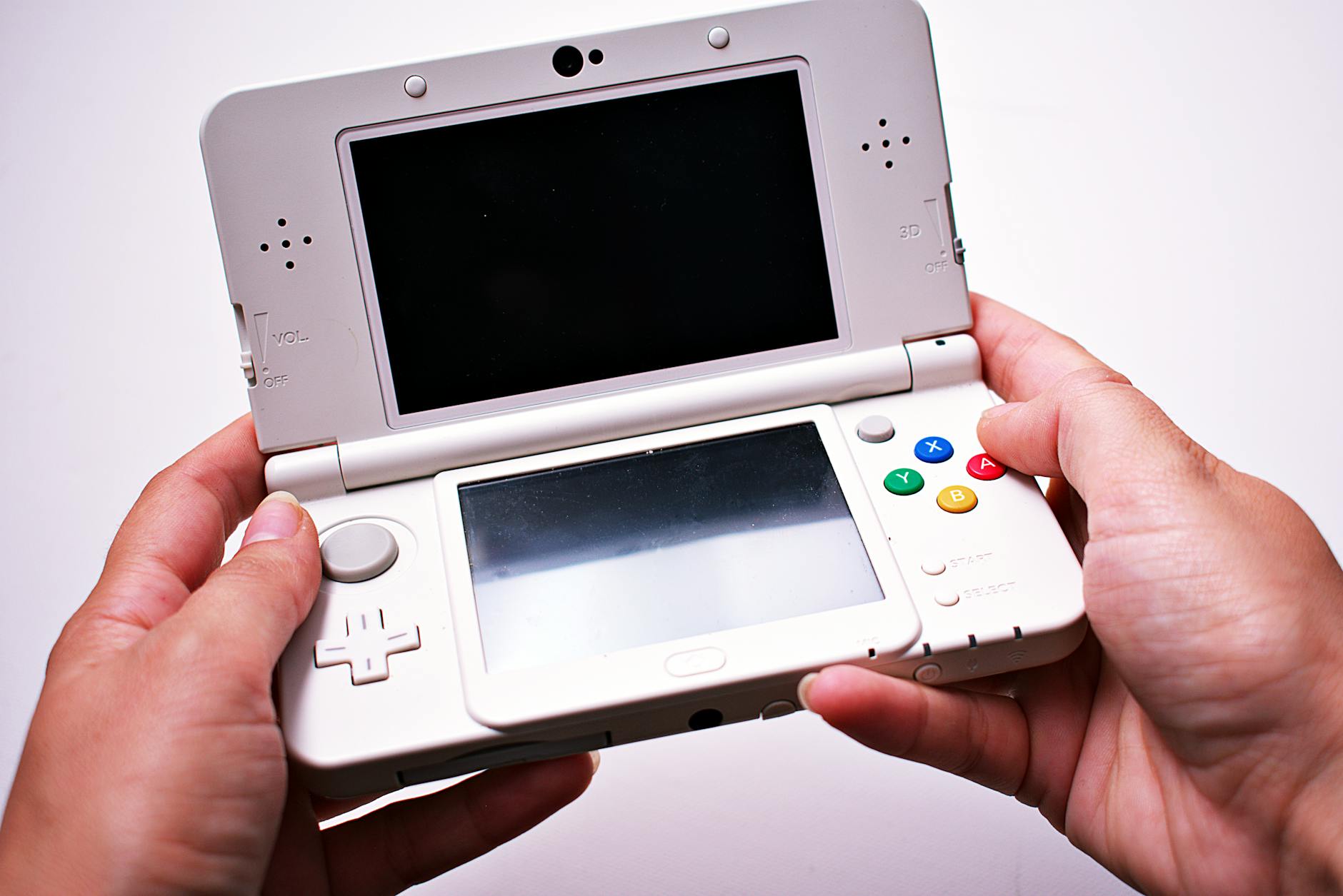 Person using handheld gaming device in comfortable indoor setting