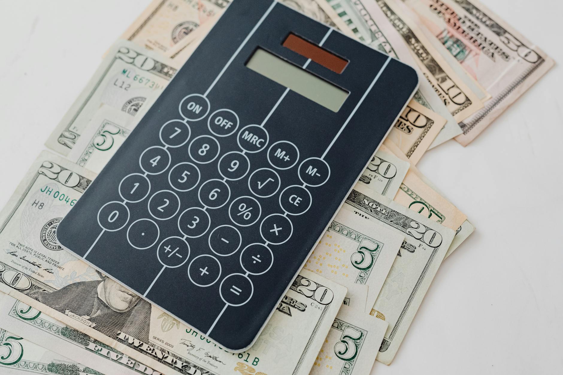 Financial calculator and international currency representing regional pricing strategies