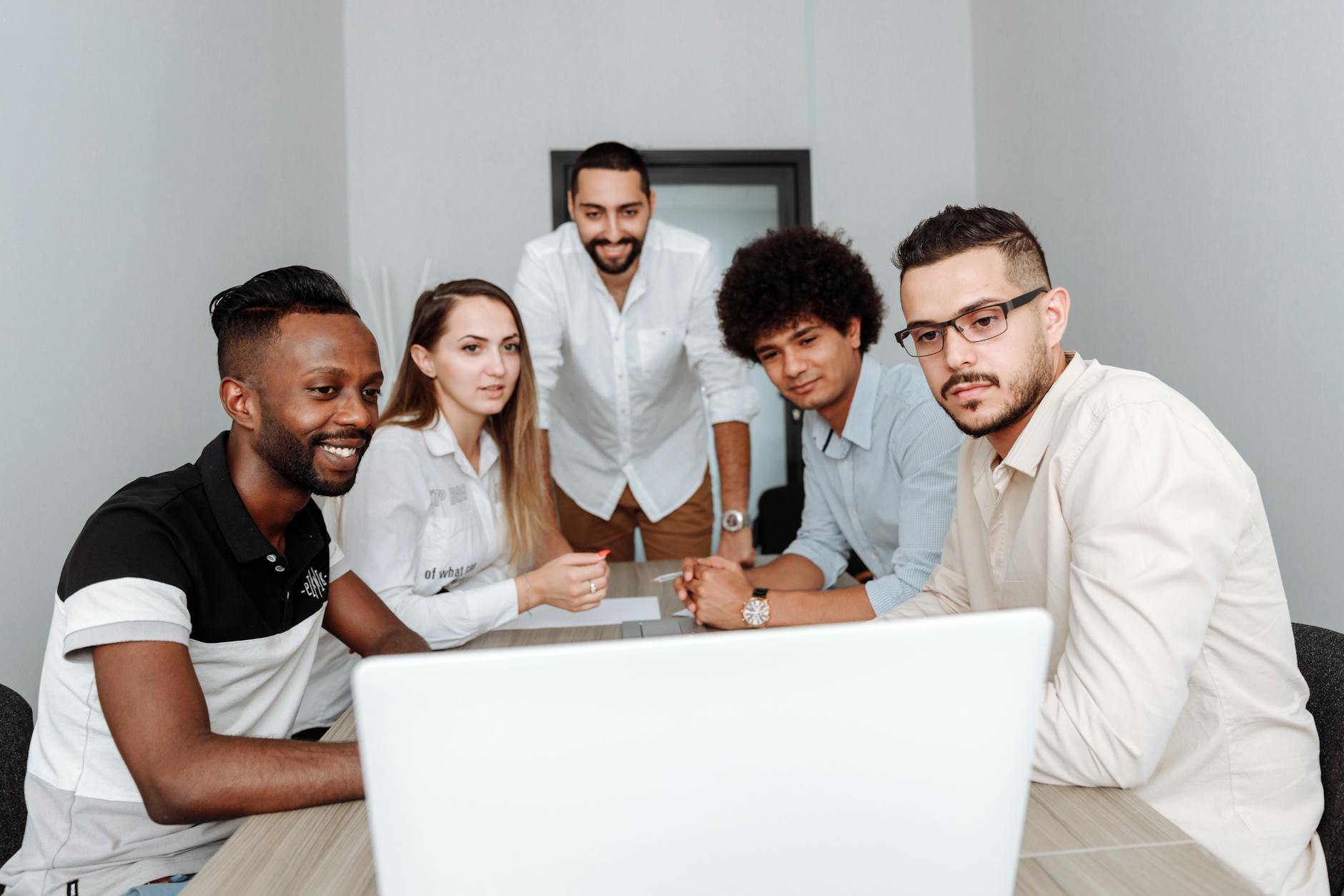 Diverse group of developers and testers collaborating in a modern gaming studio environment