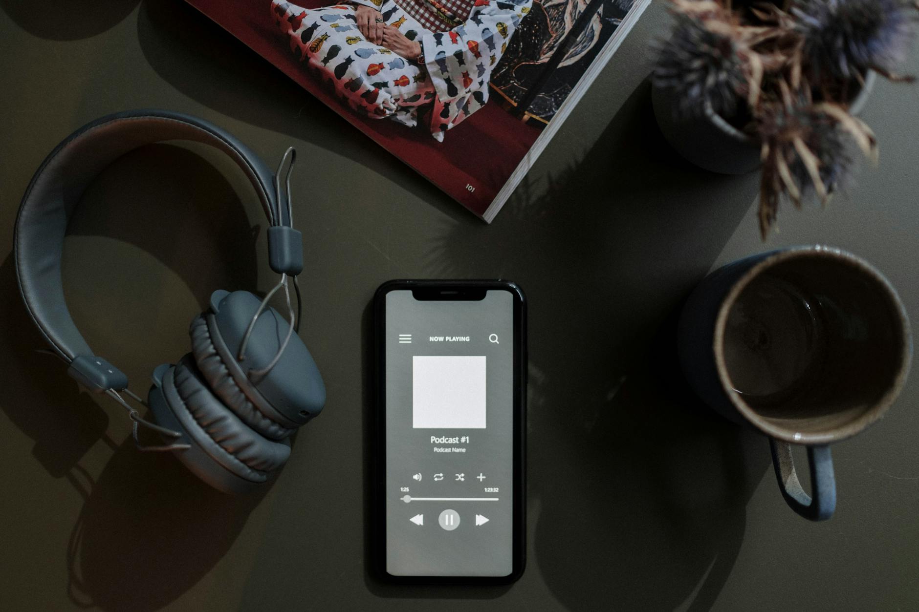 Person listening to podcasts on mobile phone with earbuds