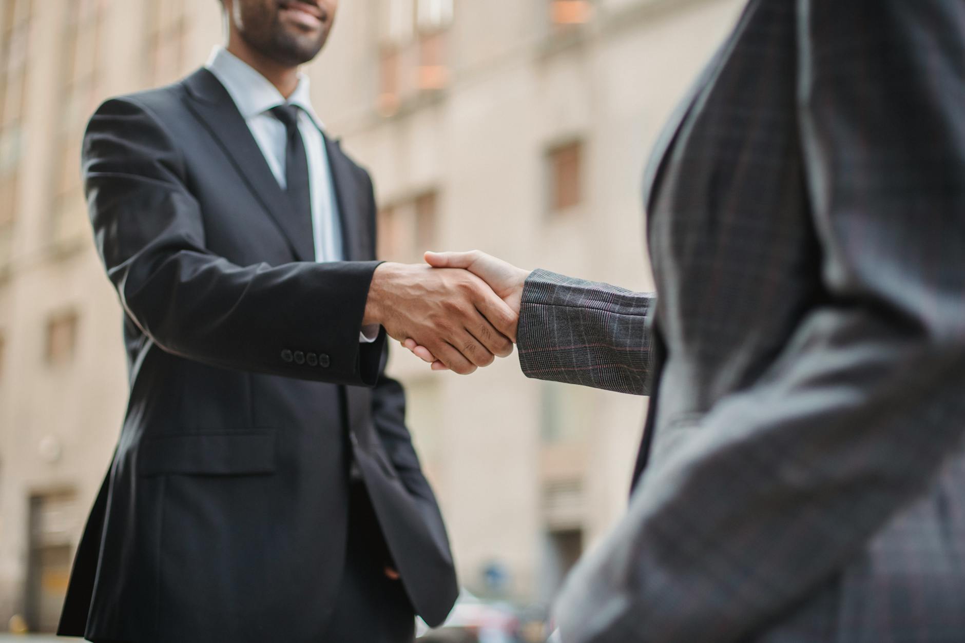 Professional handshake symbolizing partnerships between Microsoft and independent game developers