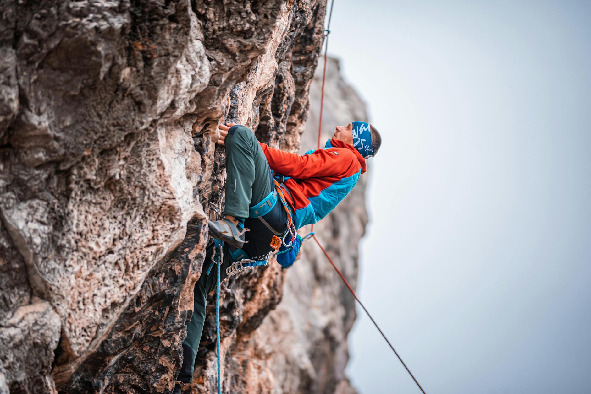 Person climbing rocky mountain terrain symbolizing exploration and adventure in gaming