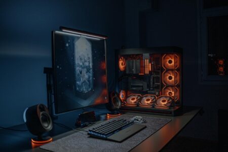 Epic Games Store’s New Family Sharing Features Mirror Steam’s Latest Updates Modern gaming computer setup with multiple monitors displaying game interfaces