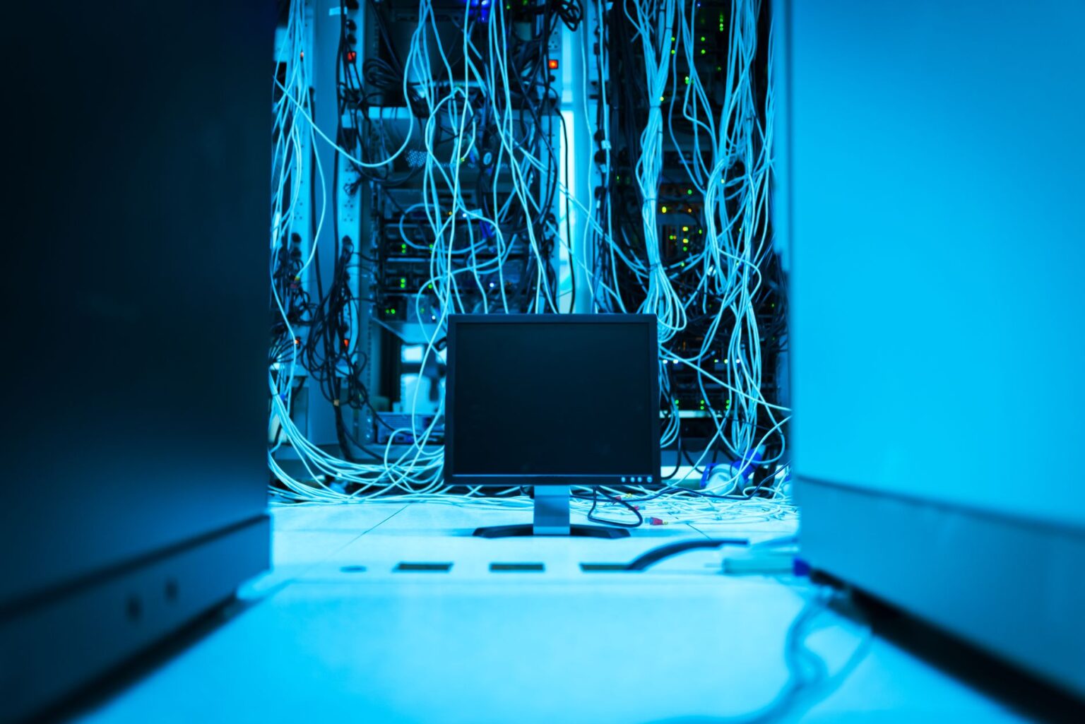 Rows of servers in a large data center with blue lighting