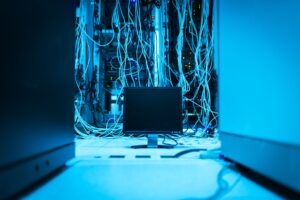 Rows of servers in a large data center with blue lighting