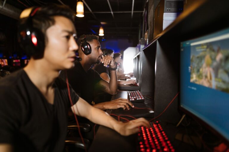 A gaming PC setup with a monitor displaying a game library interface