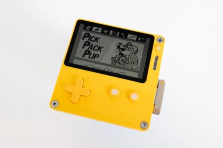 A vintage handheld gaming device resting on a flat surface, evoking classic portable gaming nostalgia