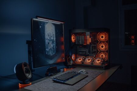 A dark gaming setup with multiple monitors, representing the Halo modding community's workstation environment