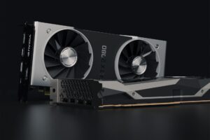 A modern graphics card displayed on a dark surface highlighting its cooling design