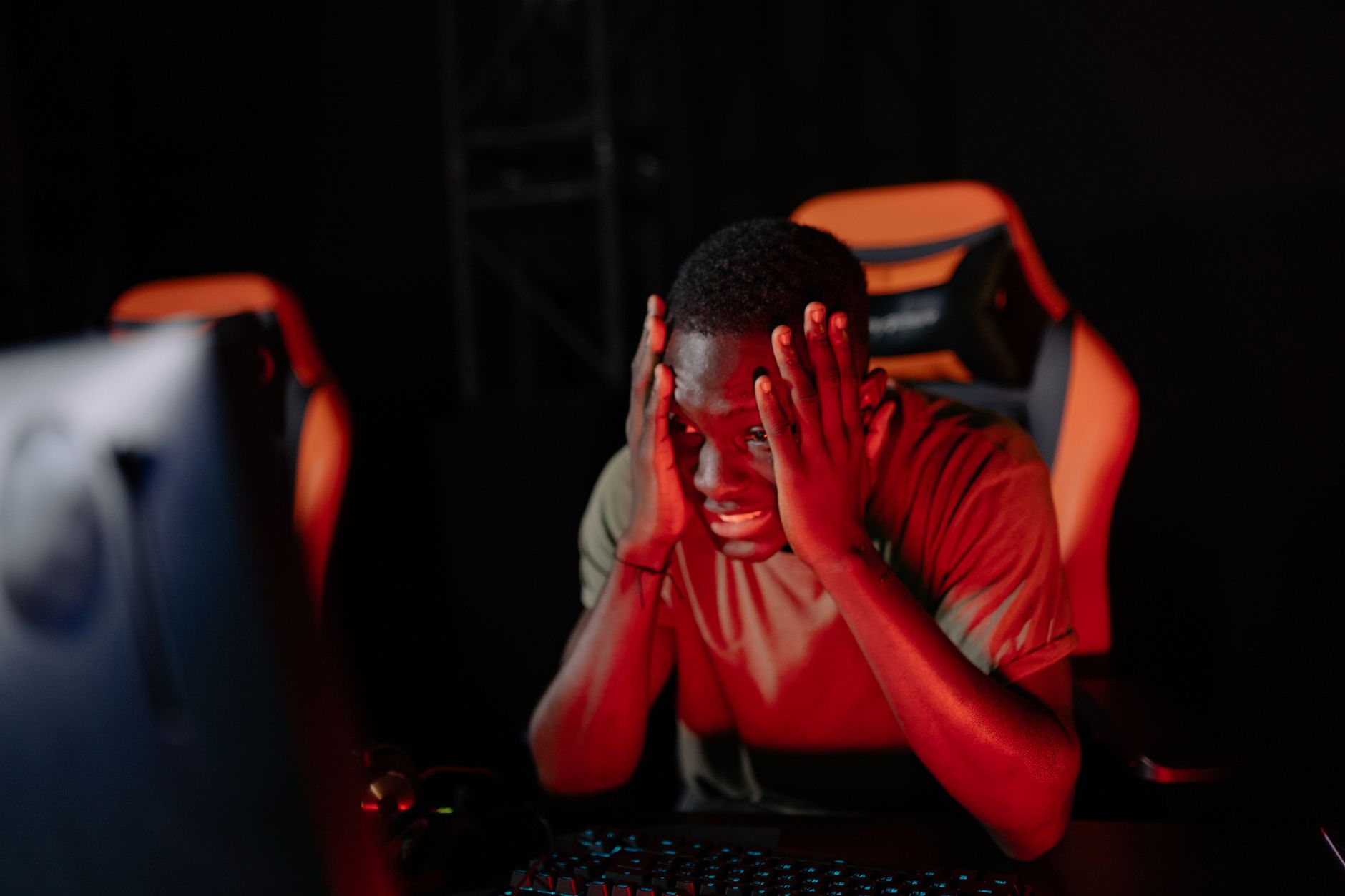 A gamer looking frustrated at a screen, reflecting fan impatience with Nintendo's silence