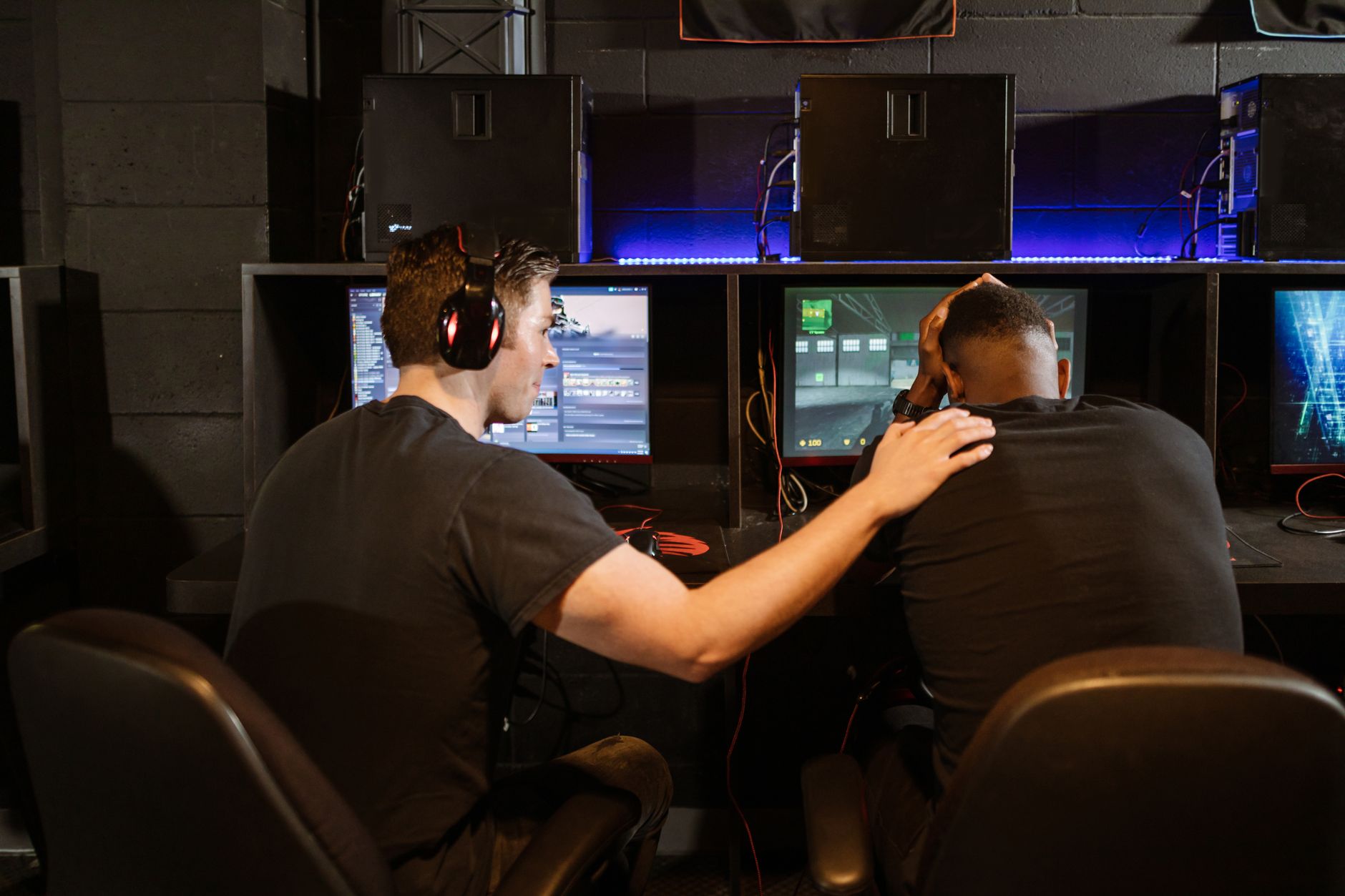 Person sitting at a computer looking frustrated, representing player backlash against exclusivity deals