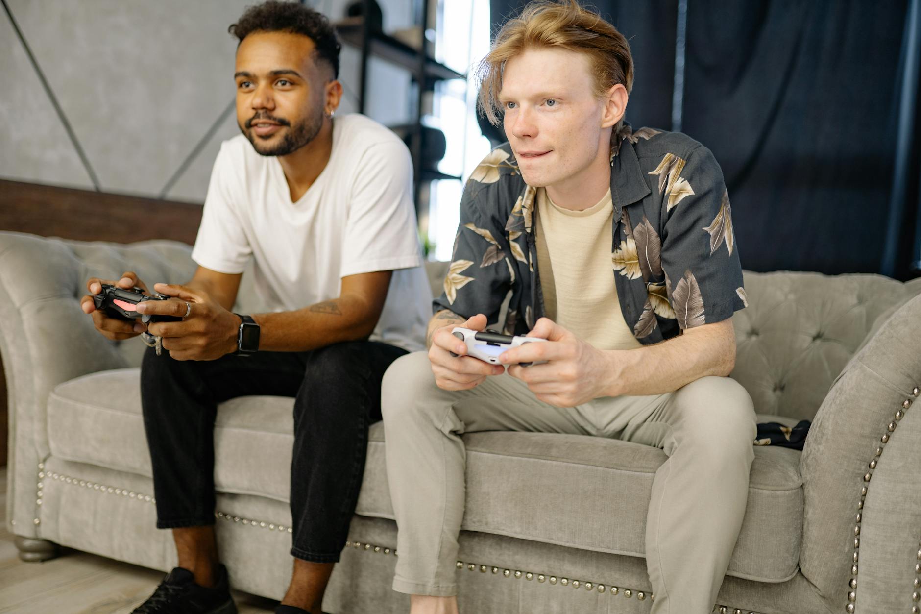 Friends sitting together playing video games in a shared space