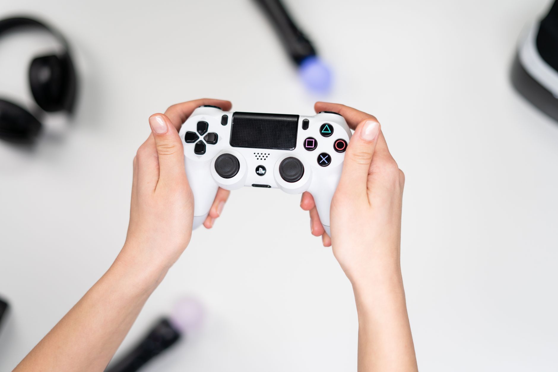 A person's hands holding a game controller during play