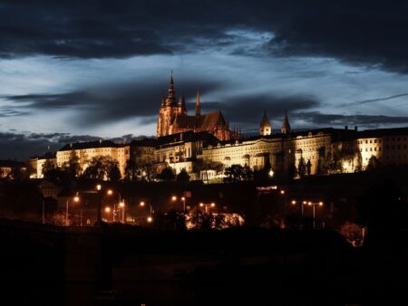 A dark gothic castle illuminated at night, evoking the visual atmosphere of the Castlevania franchise