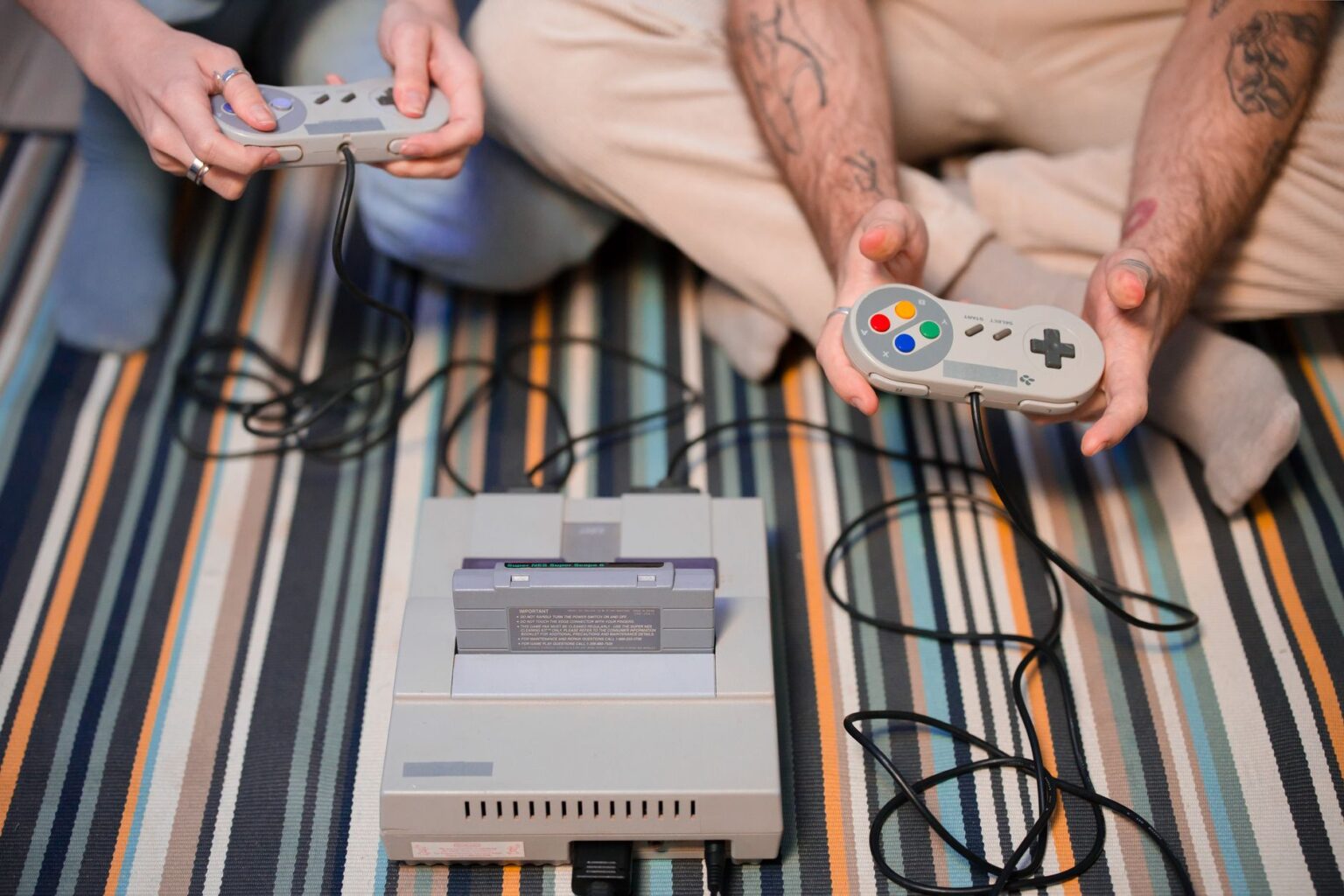 A vintage gaming console and controller representing classic Nintendo-era games